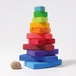 various rainbow coloured wooden pieces are stacked on top of each other