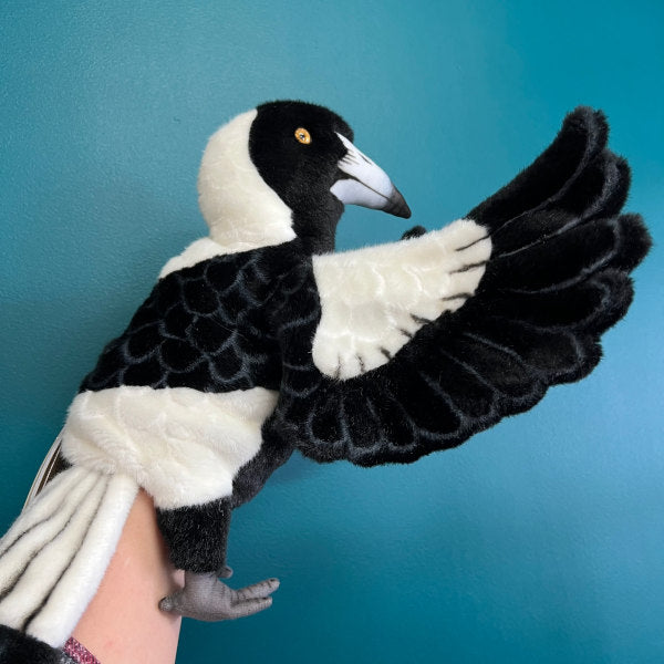 side view of plush magpie puppet showing wings and body