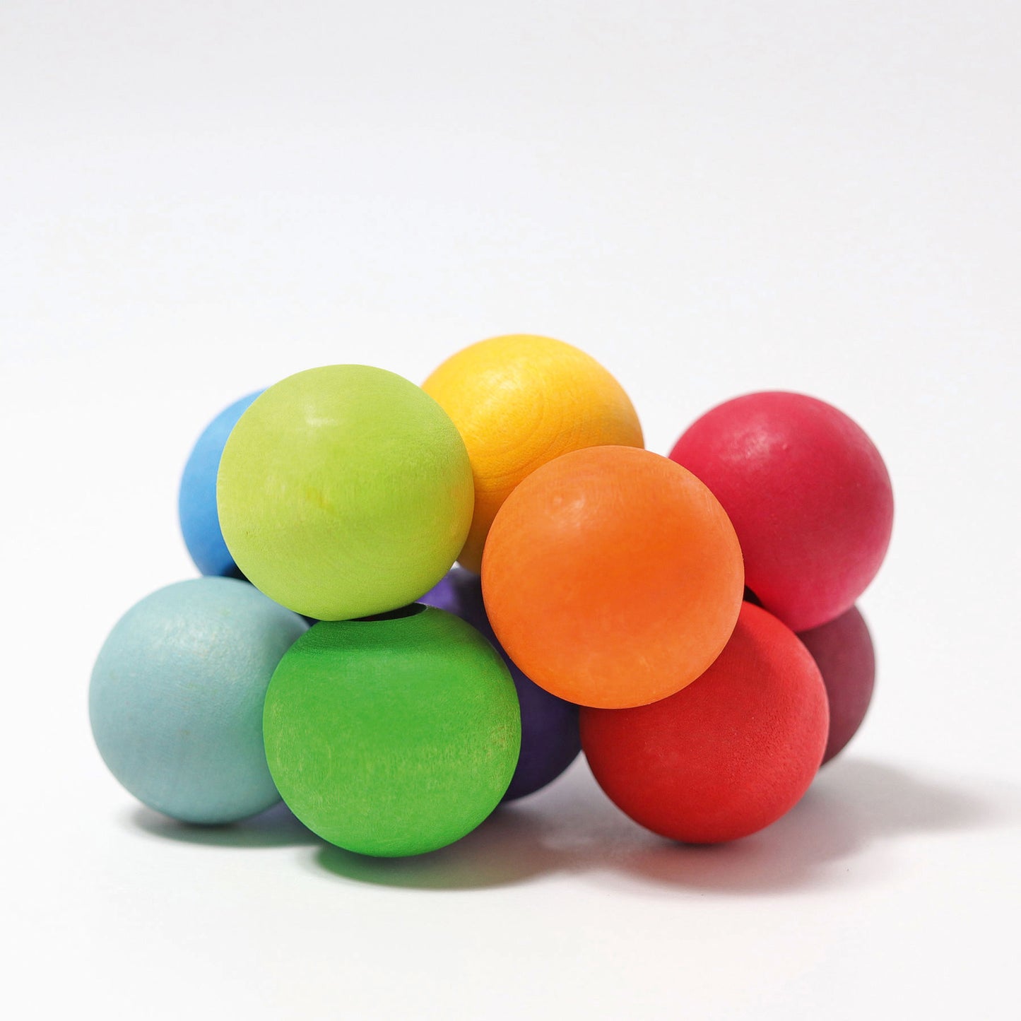 A cluster of wooden circular beads in bright rainbow colours