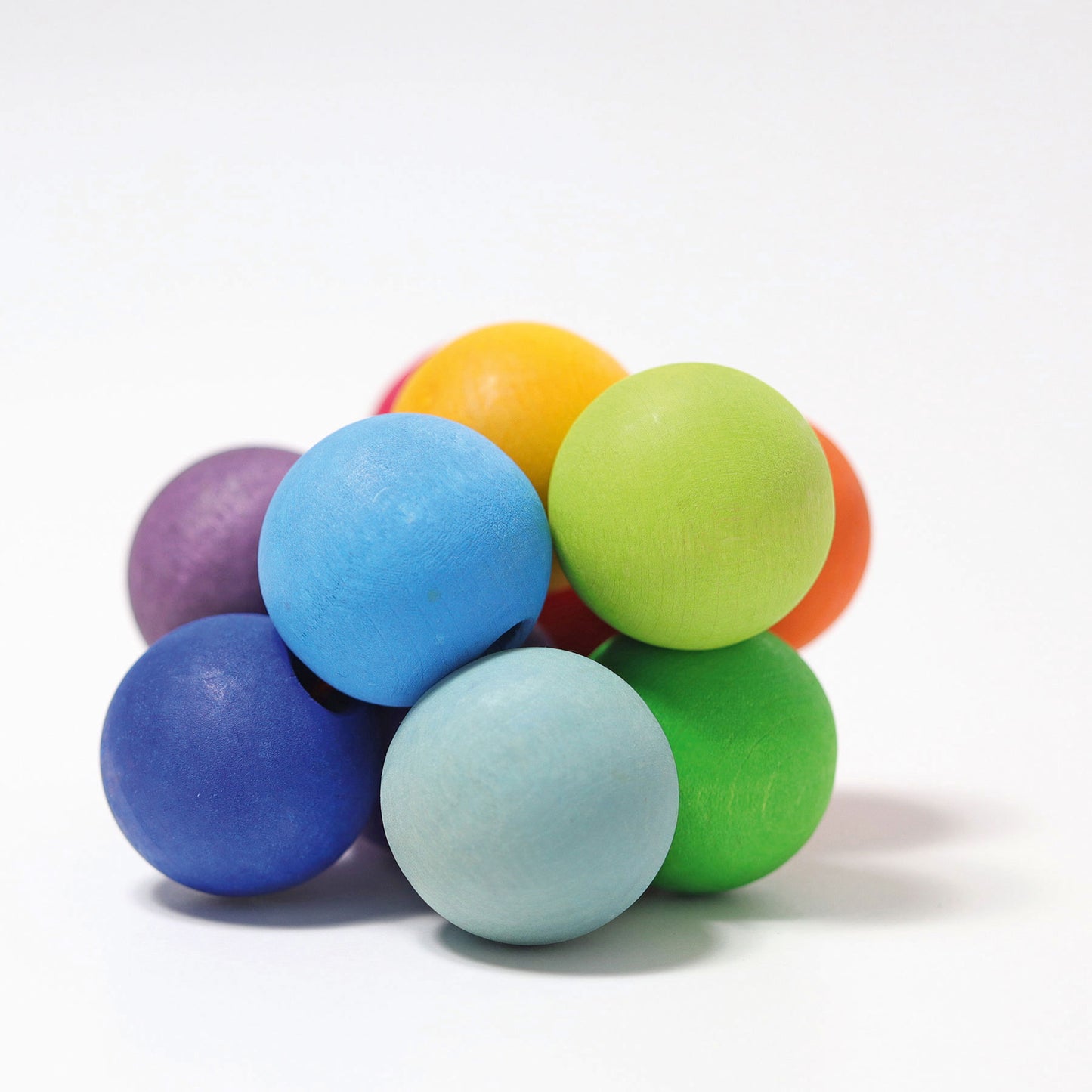 A cluster of wooden circular beads in bright rainbow colours