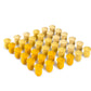 Small wooden tulip shaped mandala pieces are arranged into a square shape.  They are various shades of yellow and are grouped by shade.