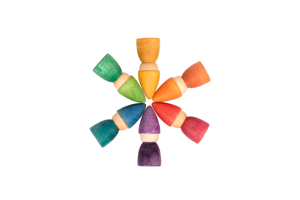 Wooden rainbow tomtens.  6 wooden carved people with cone shaped hats they are arranged in a snowflake shape