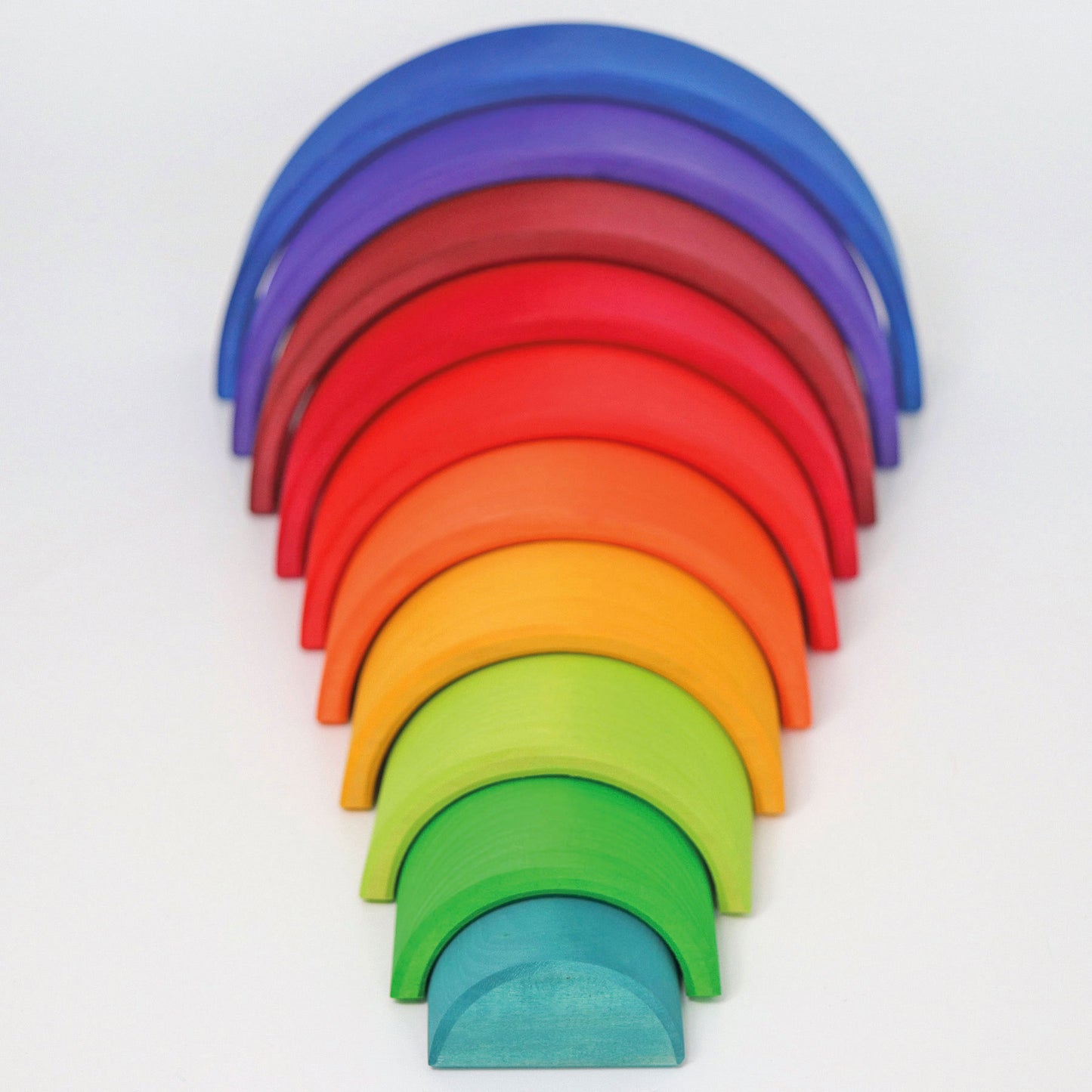 A wooden rainbow is arranged so that the arches are spread out and form a tunnel